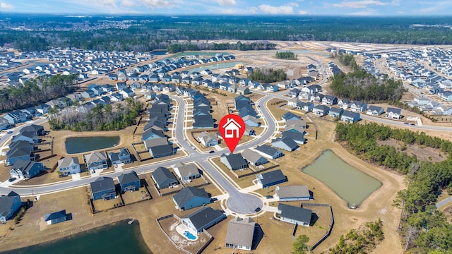 birds eye view of property featuring a water view and a residential view