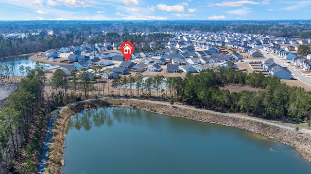 drone / aerial view featuring a residential view and a water view