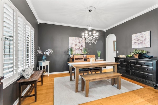 555 Pointe Of Oaks Rd, Summerville, SC 29485 - dining space with arched walkways, crown molding, light wood-style floors, a chandelier, and baseboards