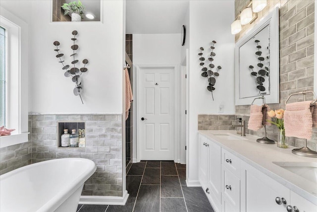 555 Pointe Of Oaks Rd, Summerville, SC 29485 - bathroom with a soaking tub, double vanity, tile walls, and a shower stall