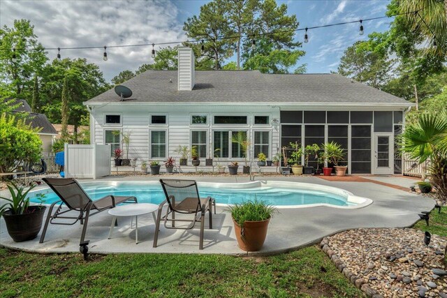 555 Pointe Of Oaks Rd, Summerville, SC 29485 - back of house with a chimney, an outdoor pool, a sunroom, and a patio area