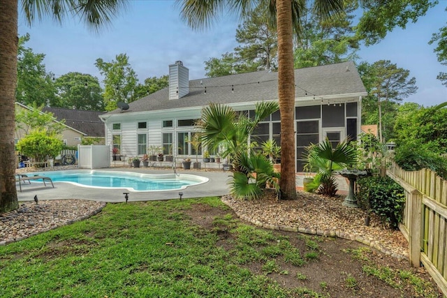 555 Pointe Of Oaks Rd, Summerville, SC 29485 - back of property featuring a sunroom, a fenced backyard, a chimney, and a patio