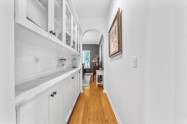 555 Pointe Of Oaks Rd, Summerville, SC 29485 - corridor with arched walkways, light wood-style floors, crown molding, and baseboards