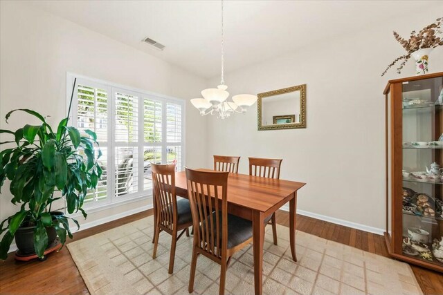 2132 Summerwood Dr, Mount Pleasant, SC 29466 - dining area with a chandelier, plenty of natural light, wood finished floors, and baseboards