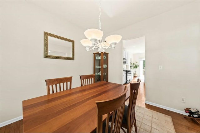 2132 Summerwood Dr, Mount Pleasant, SC 29466 - dining room with baseboards, a chandelier, and wood finished floors