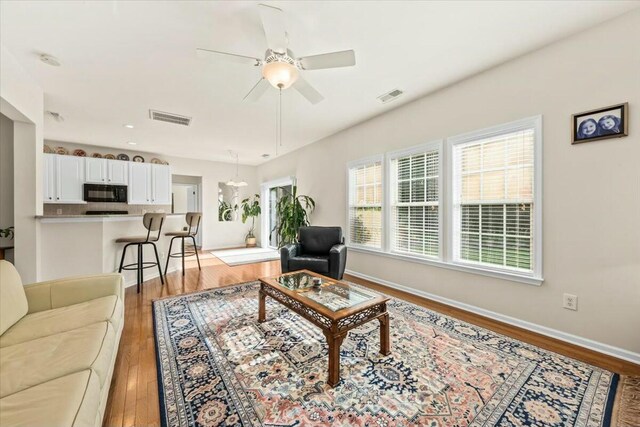2132 Summerwood Dr, Mount Pleasant, SC 29466 - living area featuring light wood finished floors, ceiling fan, and baseboards