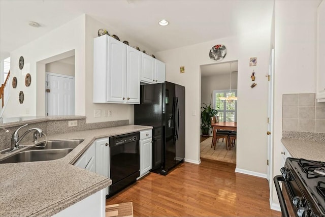 2132 Summerwood Dr, Mount Pleasant, SC 29466 - kitchen with black appliances, a sink, light wood-style floors, white cabinetry, and light countertops