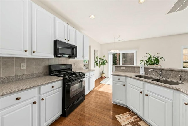 2132 Summerwood Dr, Mount Pleasant, SC 29466 - kitchen featuring black appliances, a sink, backsplash, white cabinetry, and wood finished floors