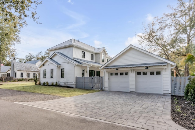 view of front of home featuring a garage and a front lawn