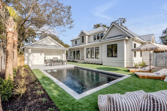 back of property featuring a pool with hot tub and a patio