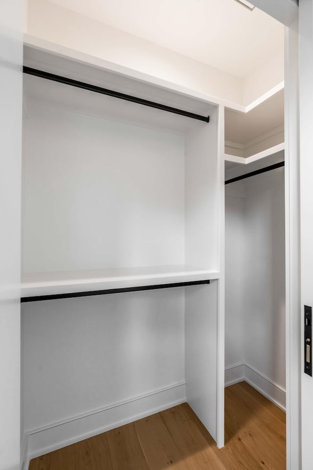 spacious closet featuring hardwood / wood-style flooring