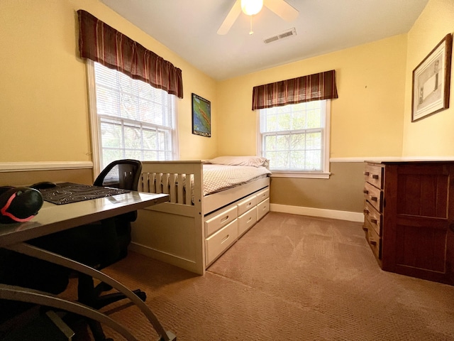 bedroom with baseboards, ceiling fan, carpet flooring, and visible vents
