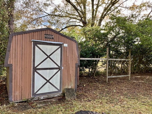 view of shed featuring fence