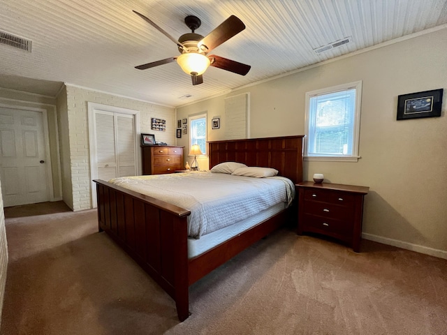 bedroom featuring light carpet, visible vents, and multiple windows