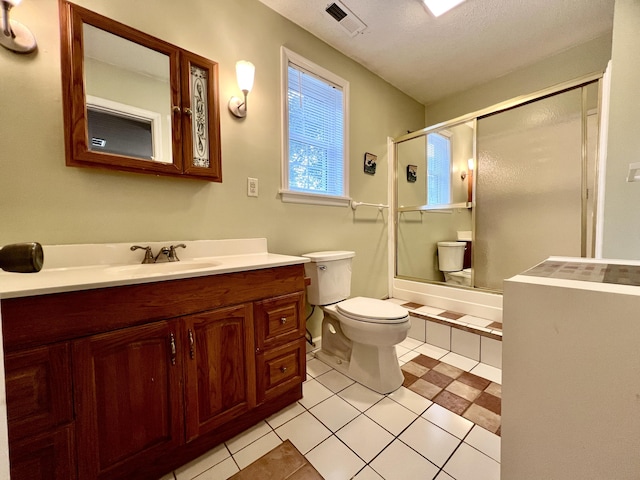 full bathroom featuring a shower with shower door, toilet, vanity, visible vents, and tile patterned floors