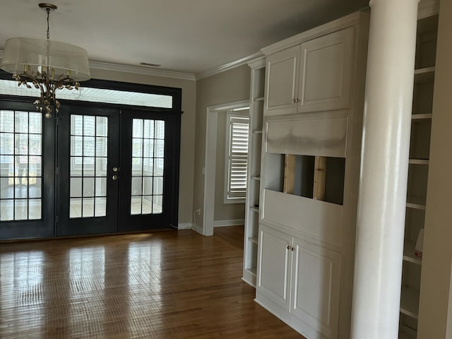 doorway with visible vents, baseboards, french doors, dark wood-style floors, and crown molding