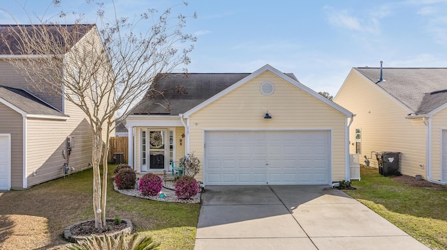 view of front of house with driveway, an attached garage, and a front yard