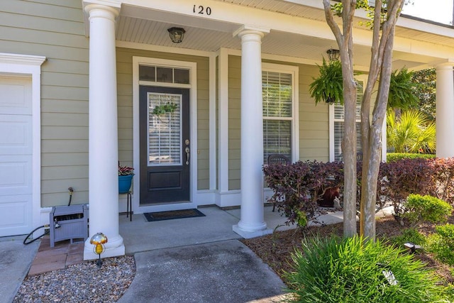 view of exterior entry with a porch