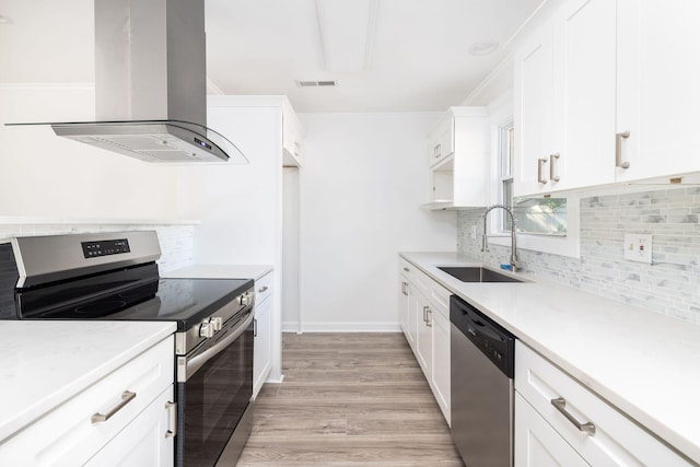 kitchen featuring sink, exhaust hood, white cabinetry, and stainless steel appliances