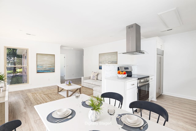 kitchen featuring range hood, white cabinets, light wood-type flooring, and stainless steel electric range oven