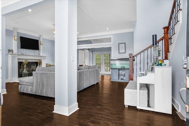 living room with a premium fireplace, crown molding, french doors, and dark wood-type flooring