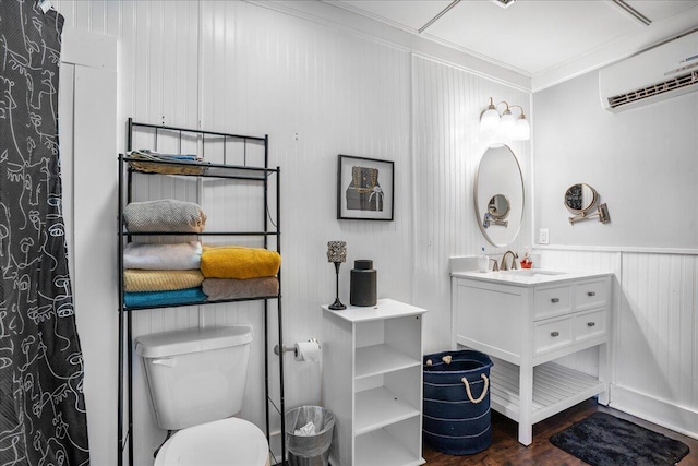 bathroom featuring hardwood / wood-style flooring, toilet, a wall mounted air conditioner, crown molding, and vanity