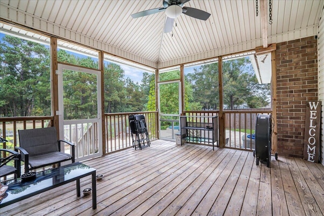 sunroom / solarium featuring ceiling fan, a healthy amount of sunlight, and wooden ceiling