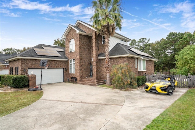 view of side of property featuring a garage, solar panels, and a lawn