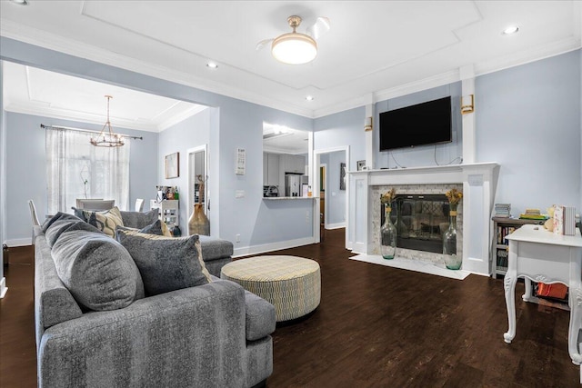 living room featuring crown molding, hardwood / wood-style flooring, and a chandelier