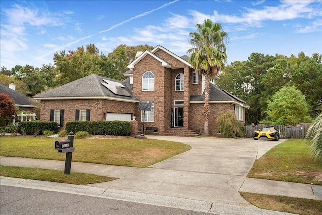 view of front property featuring a front lawn and a garage