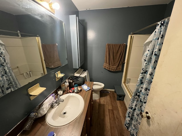 full bathroom with vanity, shower / tub combo with curtain, wood finished floors, toilet, and baseboards