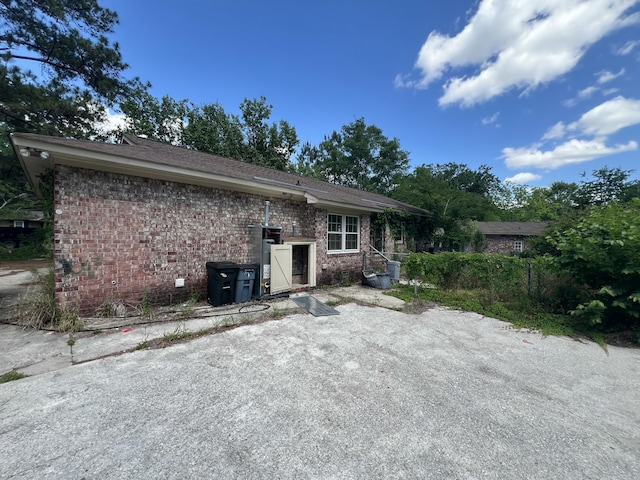 back of house with brick siding
