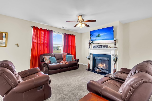 carpeted living room with ceiling fan