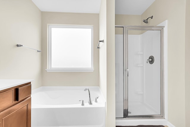 bathroom with vanity and independent shower and bath