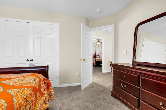 bedroom with light carpet and a closet