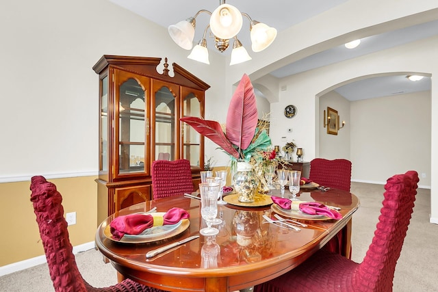 carpeted dining space with a notable chandelier