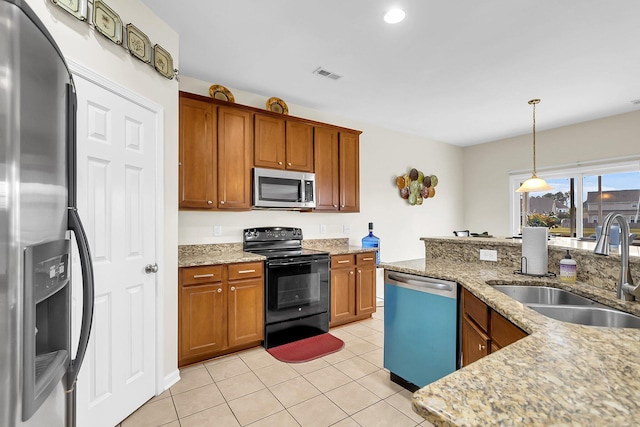 kitchen with sink, light stone counters, decorative light fixtures, light tile patterned floors, and appliances with stainless steel finishes