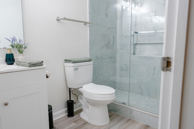 bathroom featuring hardwood / wood-style flooring, vanity, toilet, and an enclosed shower