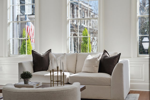 living area with plenty of natural light and wood finished floors