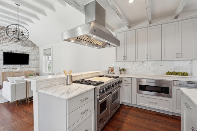 kitchen featuring open floor plan, range with two ovens, white cabinetry, and island range hood