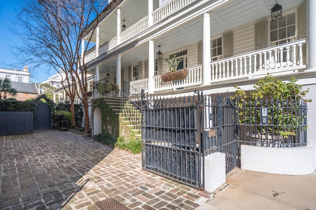 view of front facade with a balcony and a gate