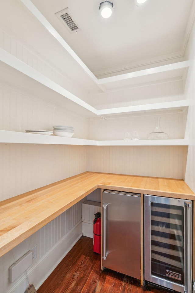 pantry featuring wine cooler and visible vents