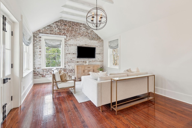 living area featuring a chandelier, brick wall, dark wood finished floors, and vaulted ceiling with beams