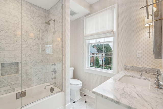 full bath with visible vents, toilet, enclosed tub / shower combo, vanity, and baseboards