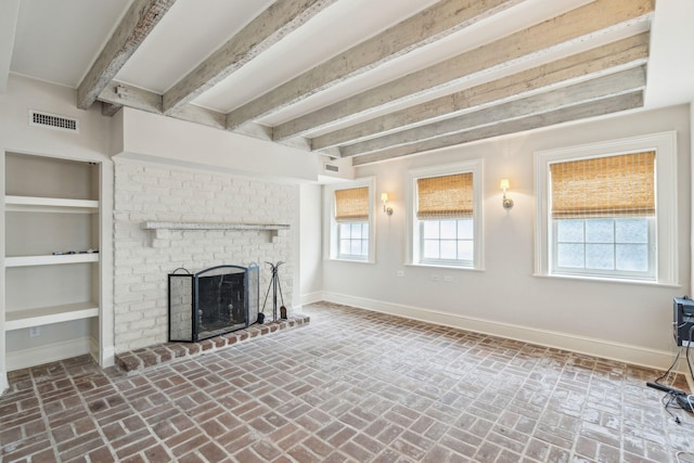 unfurnished living room featuring brick floor, a fireplace, baseboards, and beamed ceiling