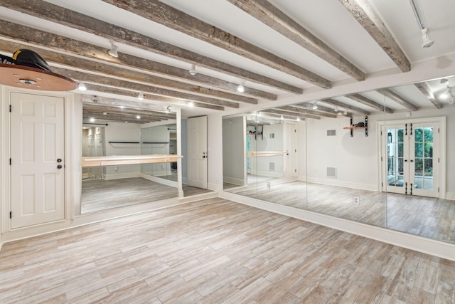 interior space featuring light wood-style flooring, visible vents, baseboards, and french doors