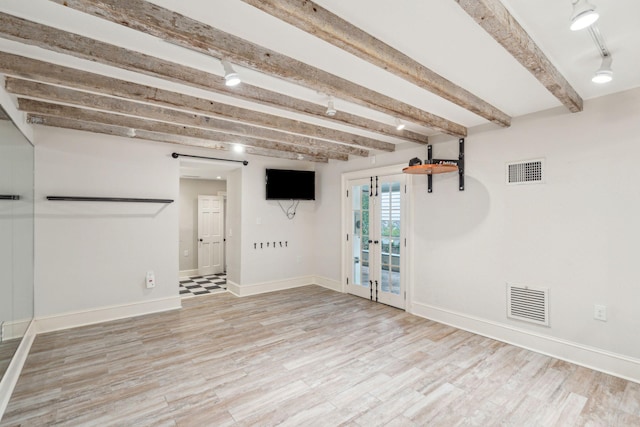 below grade area with visible vents, light wood-style flooring, and baseboards