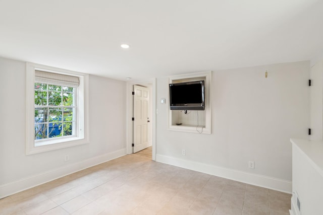 unfurnished room featuring recessed lighting and baseboards