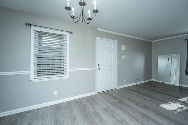 unfurnished dining area featuring hardwood / wood-style flooring, a notable chandelier, and crown molding