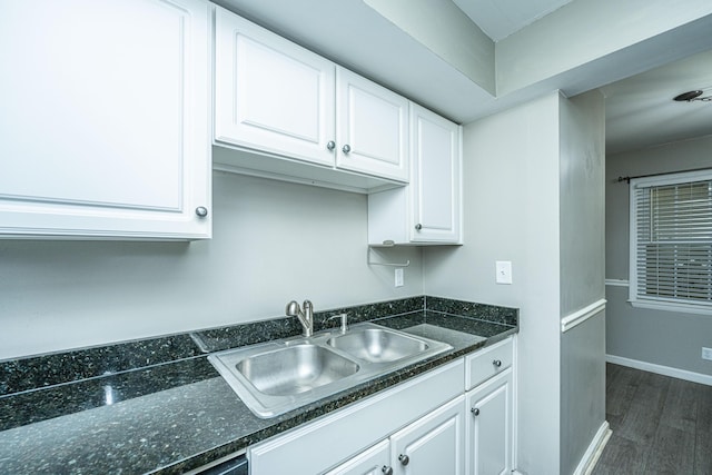 kitchen with white cabinets, dark wood-type flooring, and sink